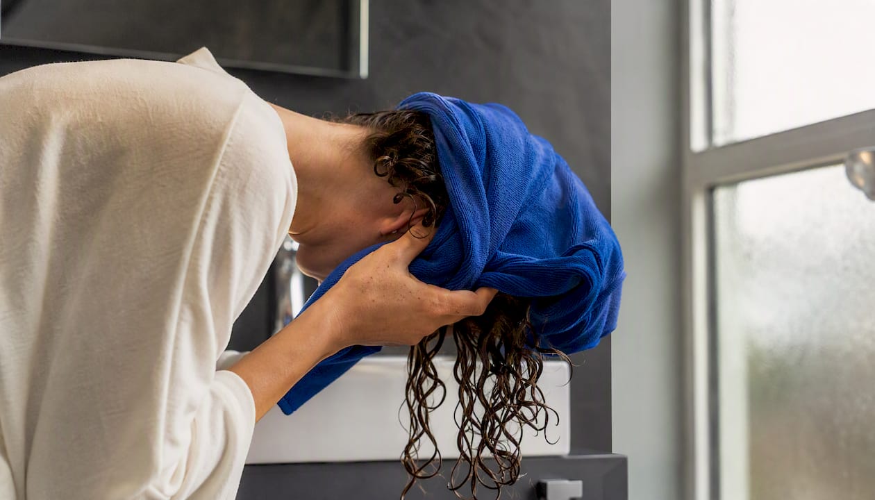 Curly hair wrapped in microfibre towel for plopping