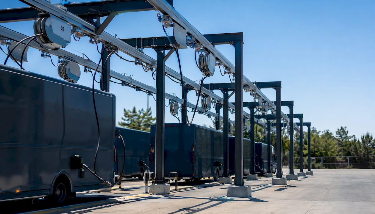 Overhead gantry cable management in logistics drive-through bay