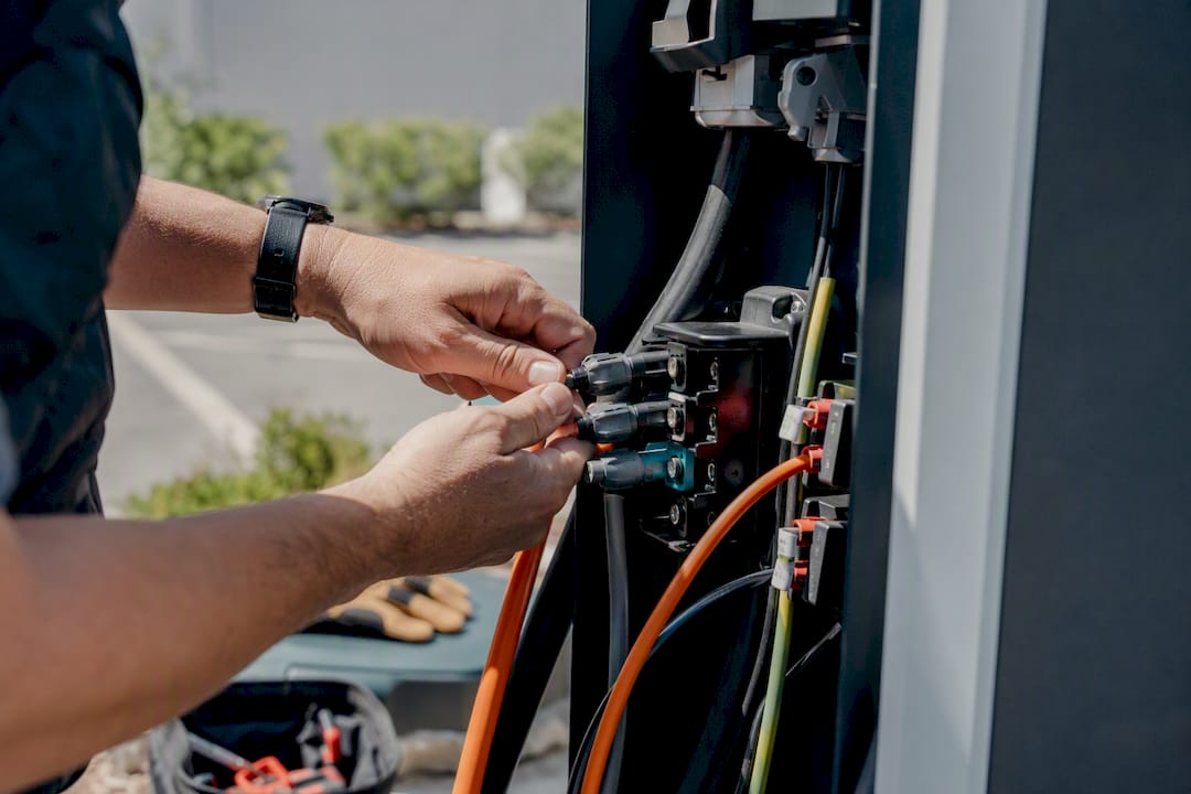 Technician hands wiring EV charger cables