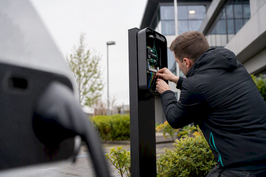 Technician wiring commercial EV charger