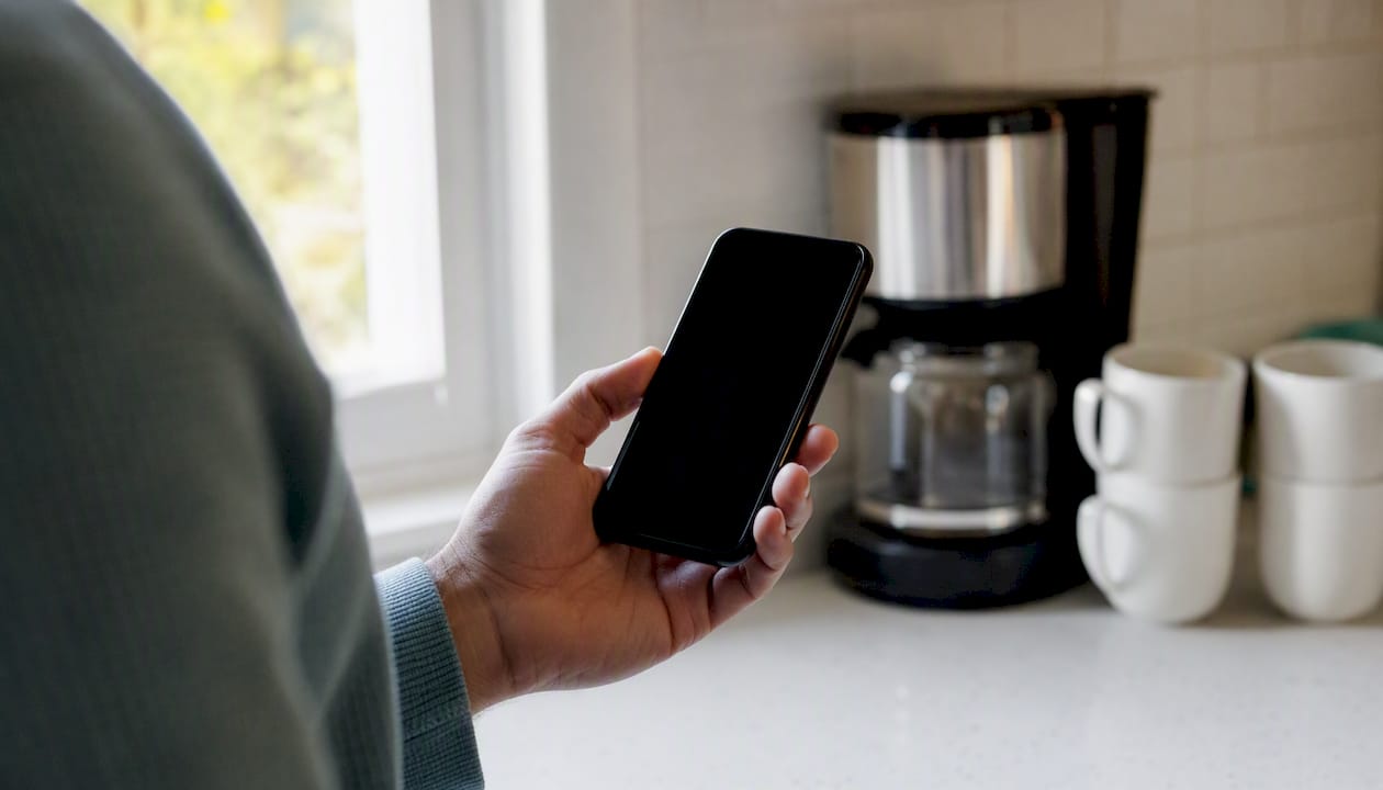 Hand holding smartphone waiting for transcript notification