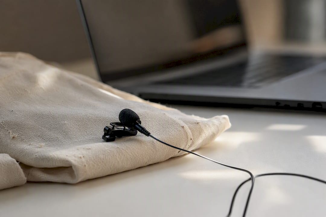 Lapel microphone on gray fabric on desk