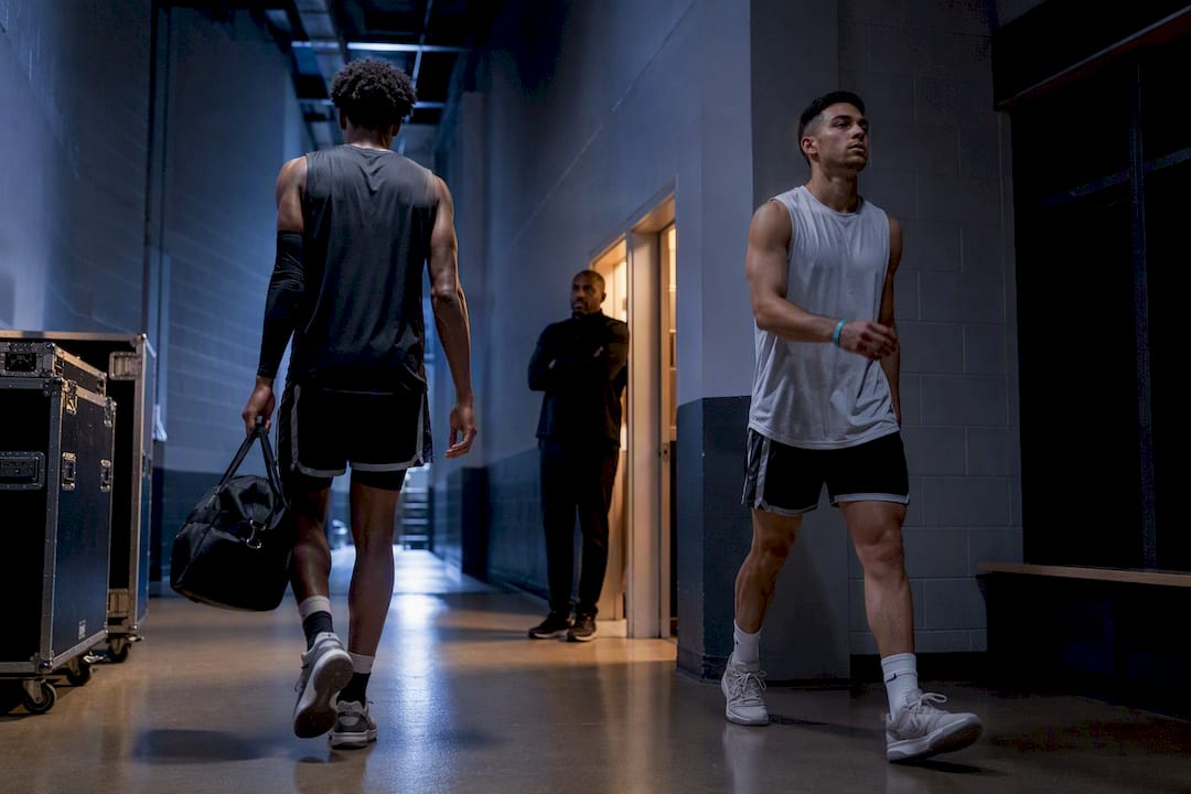 Players crossing in an arena tunnel