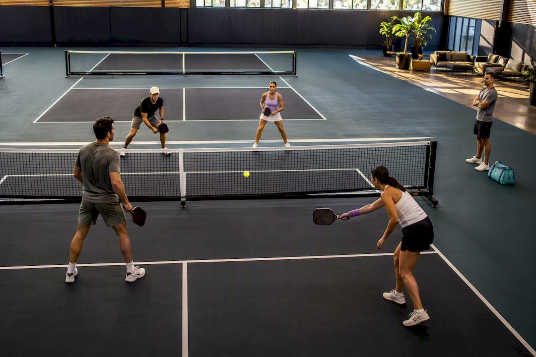 Organized pickleball games across indoor courts
