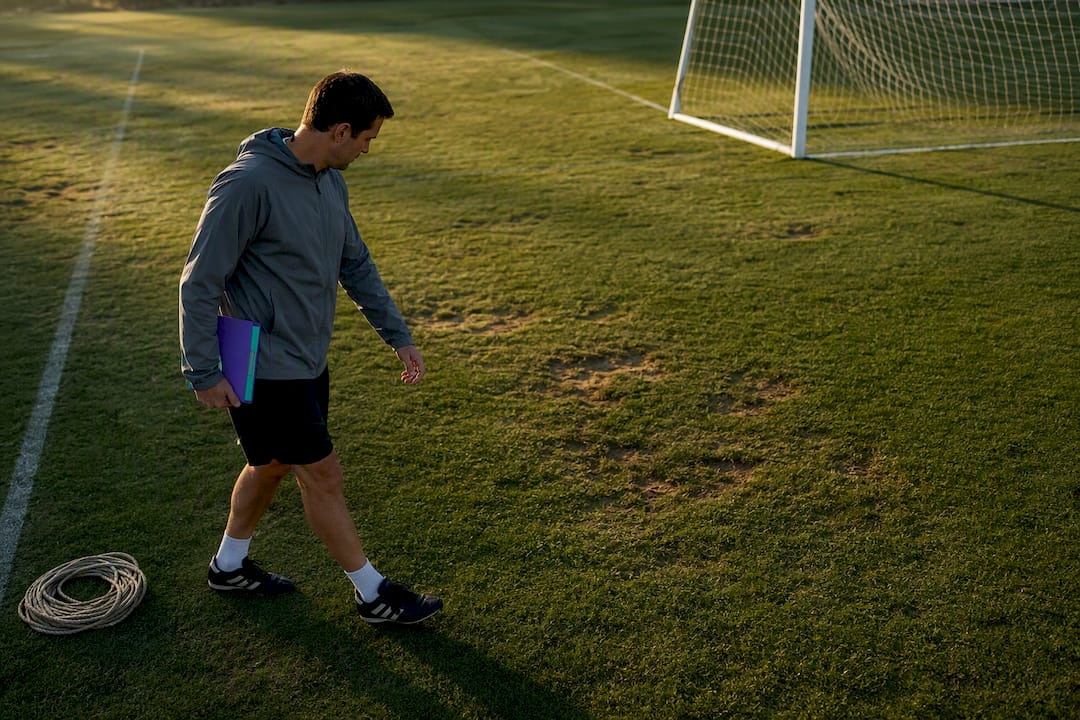 Organizer inspecting soccer field safety