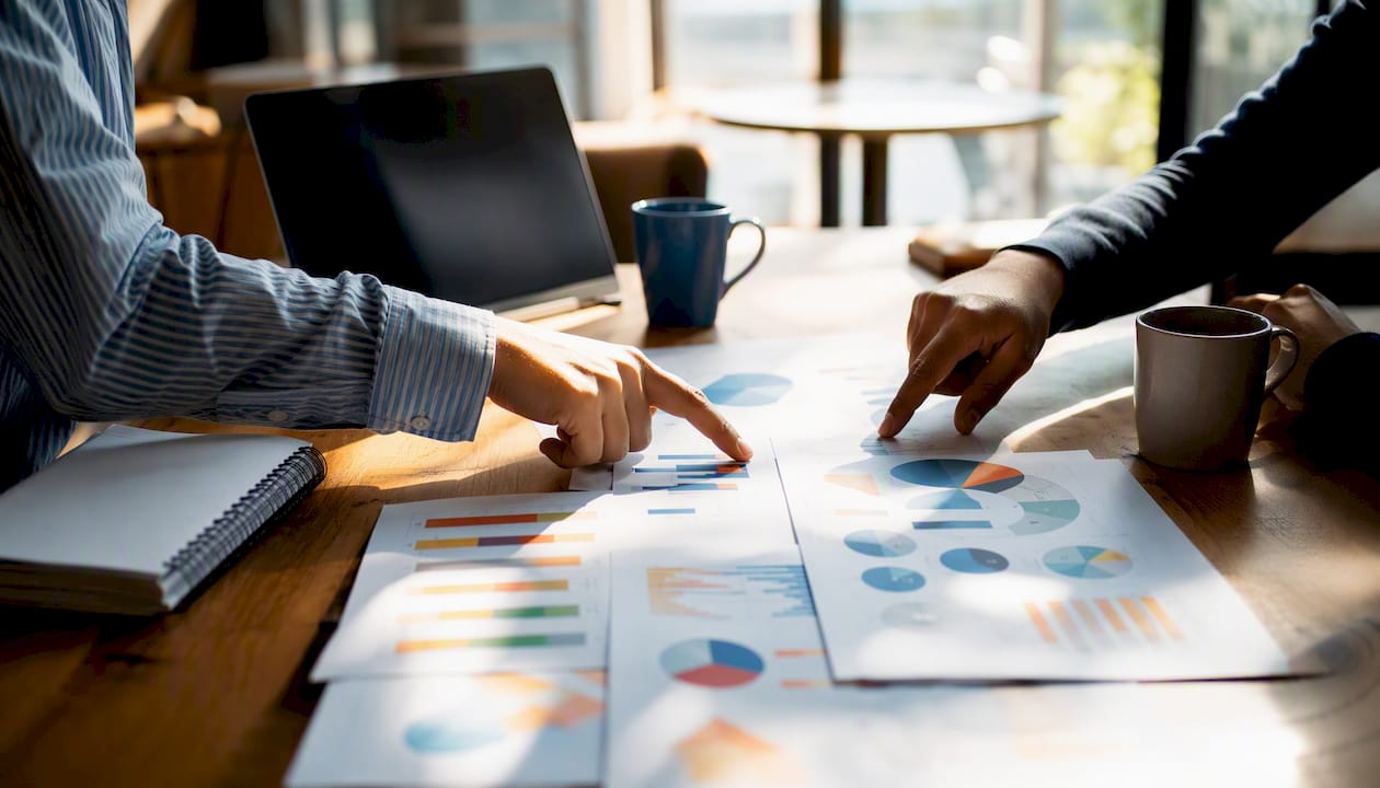 Hands manipulating printed marketing charts