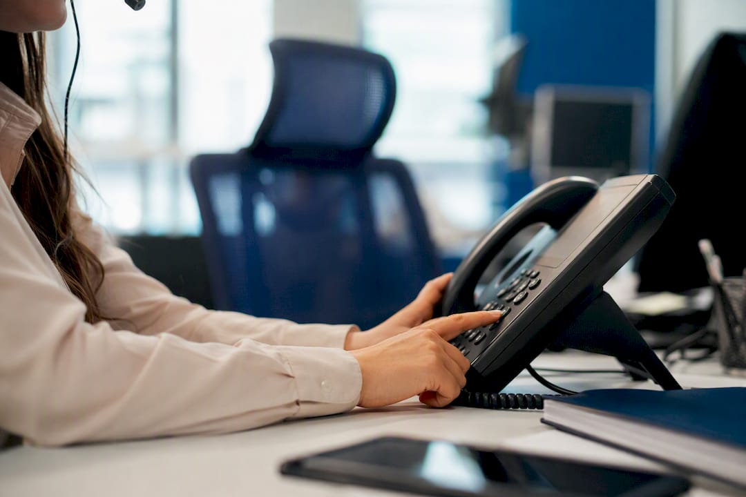 Agent's hands selecting code on phone keypad