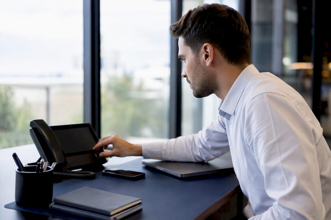 Sales rep initiating call on desk phone