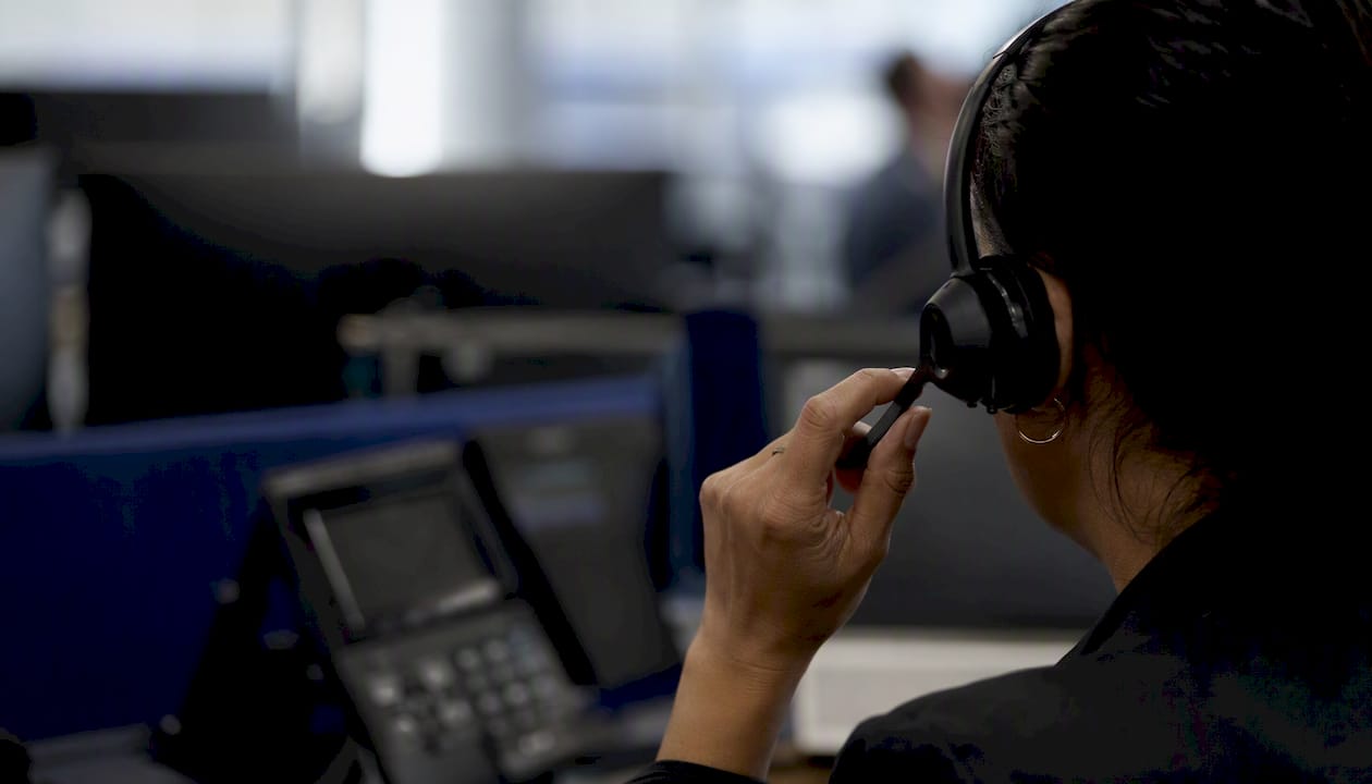 Hands adjusting insurance agent headset controls
