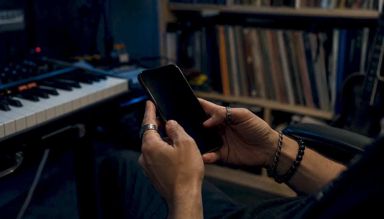 Hands holding smartphone for musician search