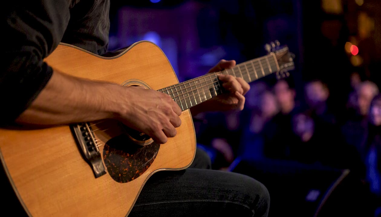 Guitarist hands playing live on stage