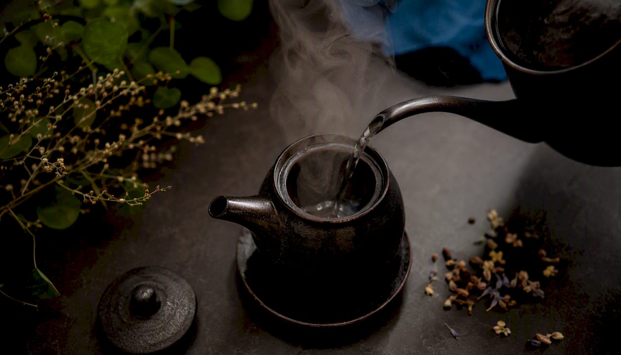 Pre-warming ceramic teapot with hot water rinse