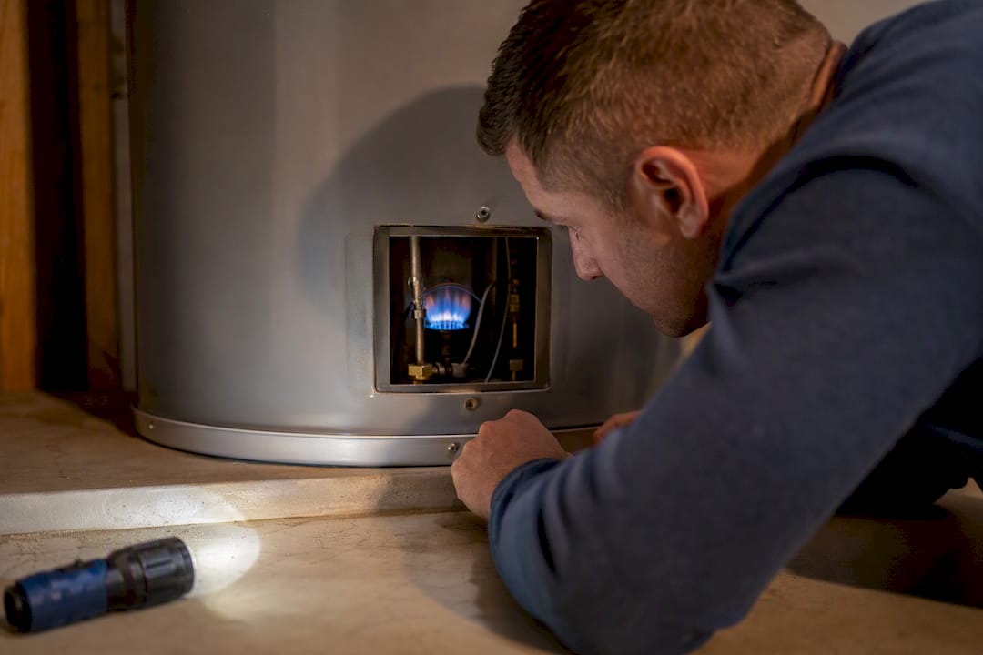 Pilot flame visible through gas heater window