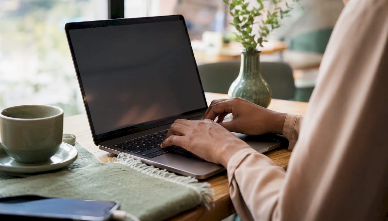 Hands configuring EHR software on laptop