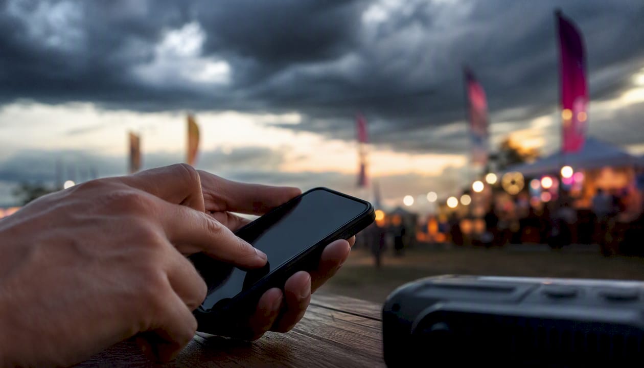 Hand sending weather alert text on phone