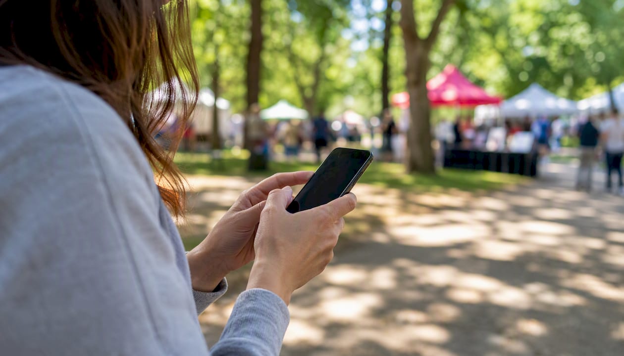 Hands typing text message on smartphone