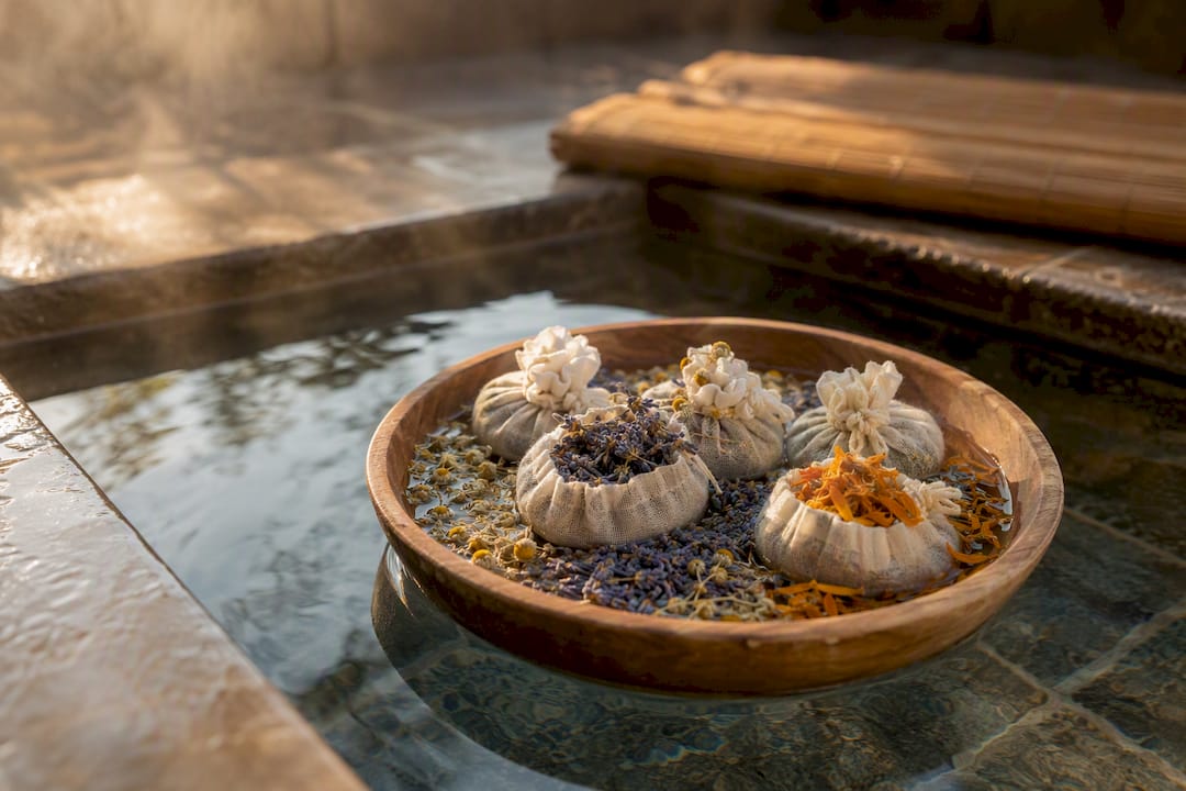 Herbal bath sachets floating in warm water