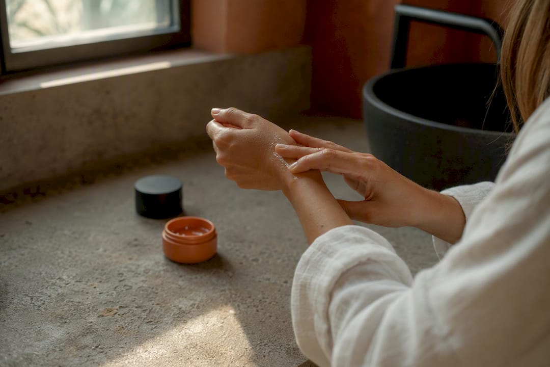 Hands applying sunscreen during skincare routine