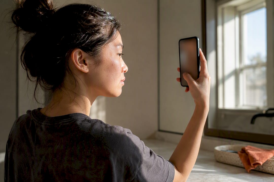 Person documenting cheek changes consistently