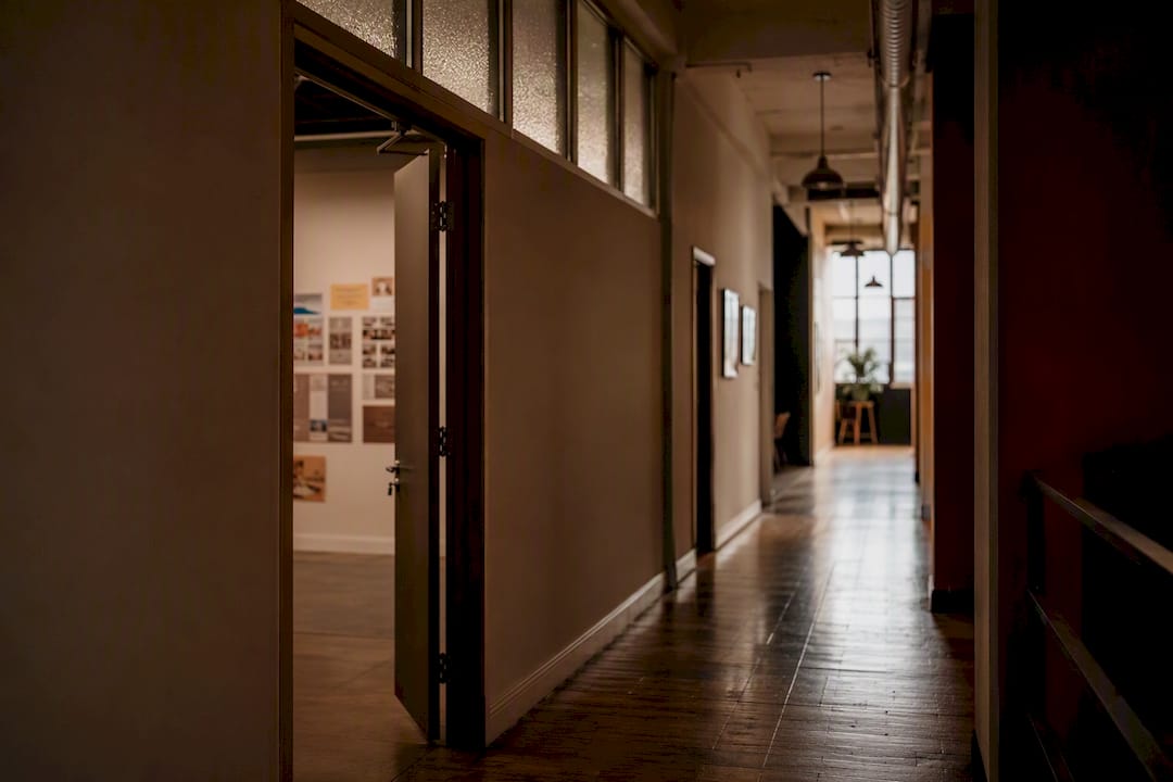 Quiet office hallway with ajar door