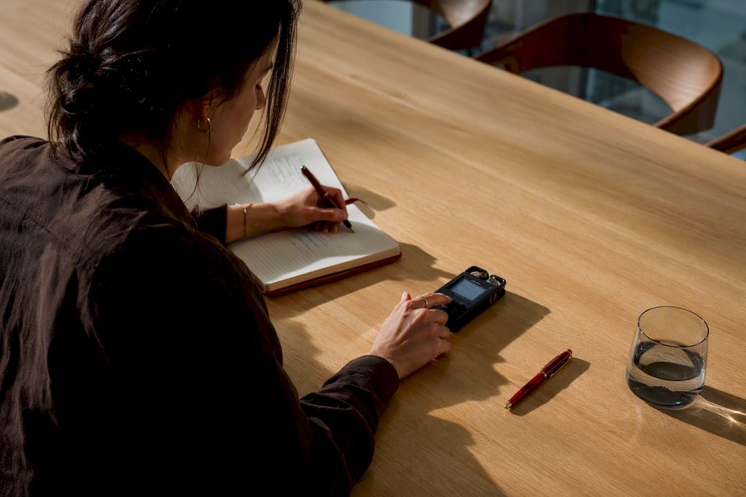 Designer capturing client meeting decision shorthand