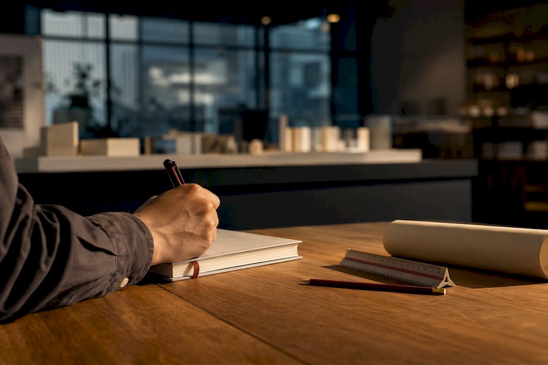 Architect recording meeting minutes in studio