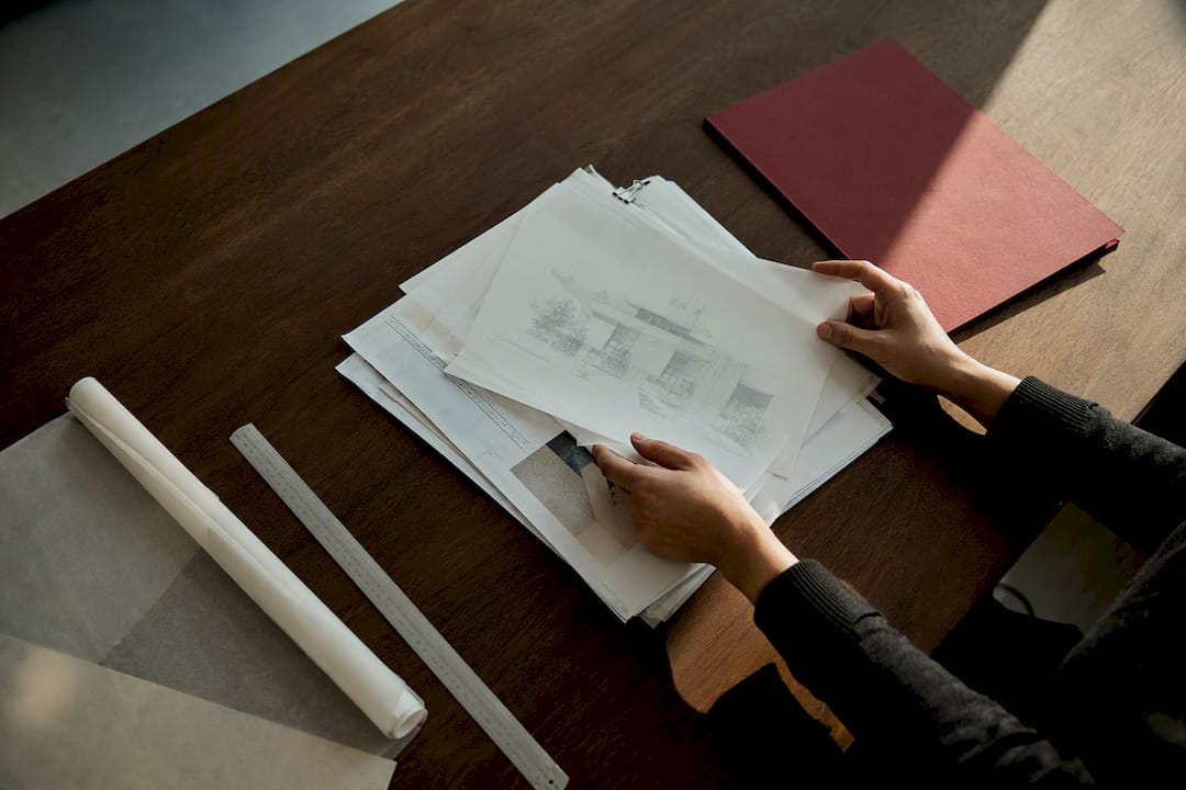 Hands organizing architectural project records