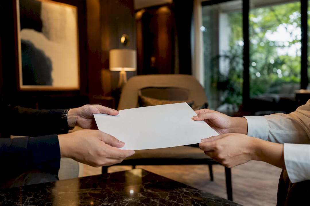 Agent handing signed property agreement