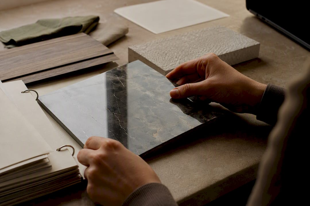 Hand inspecting damaged wood veneer sample