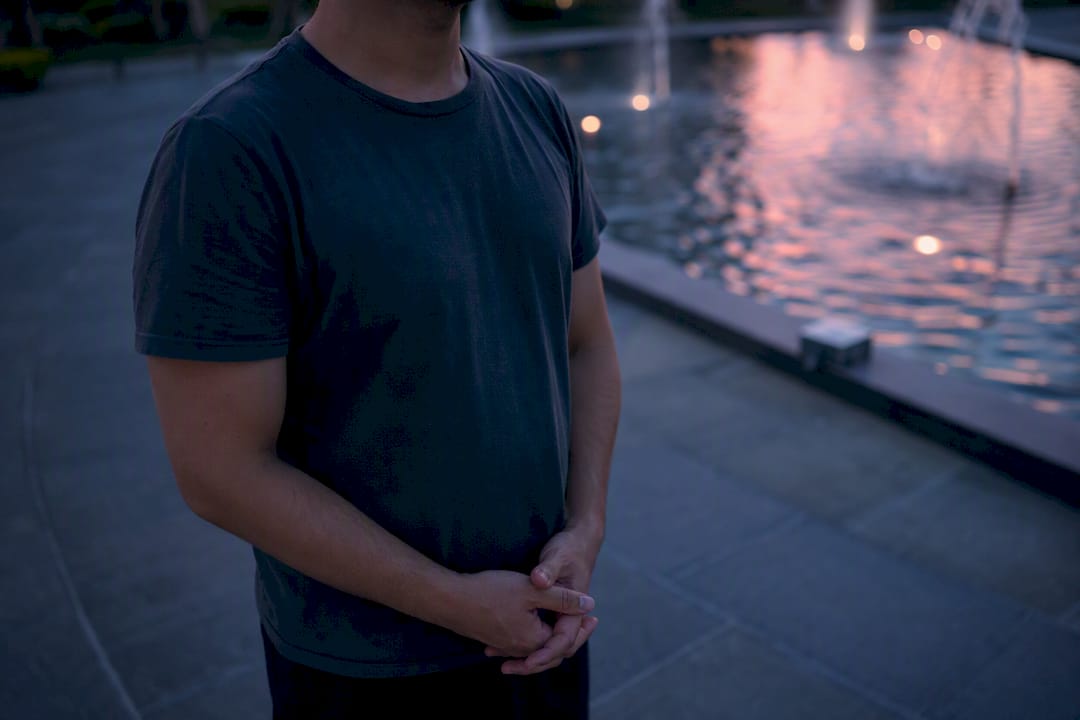 Person practicing calming breathing outdoors at dusk