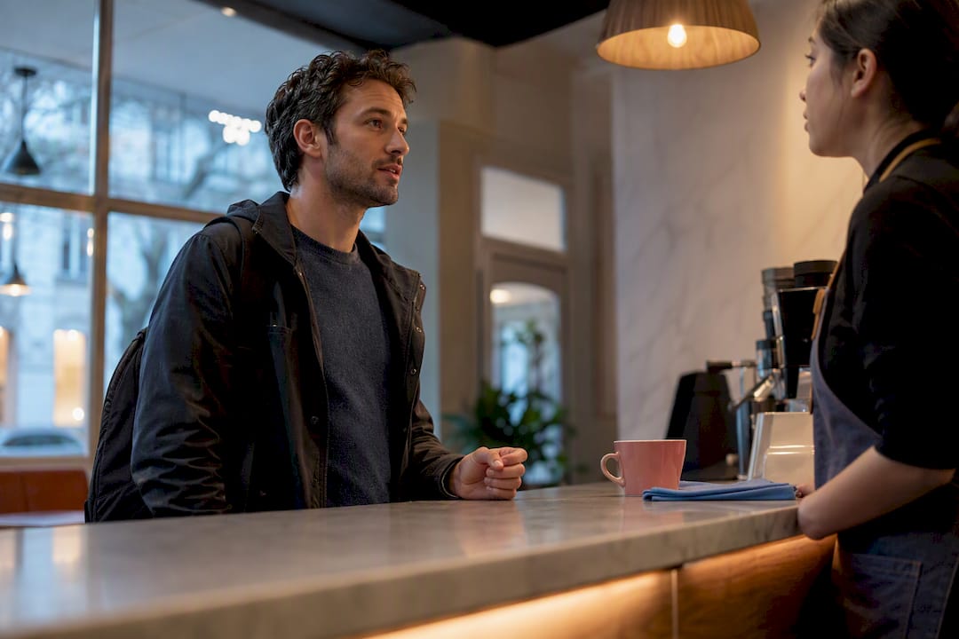 Adult practicing conversation at café counter