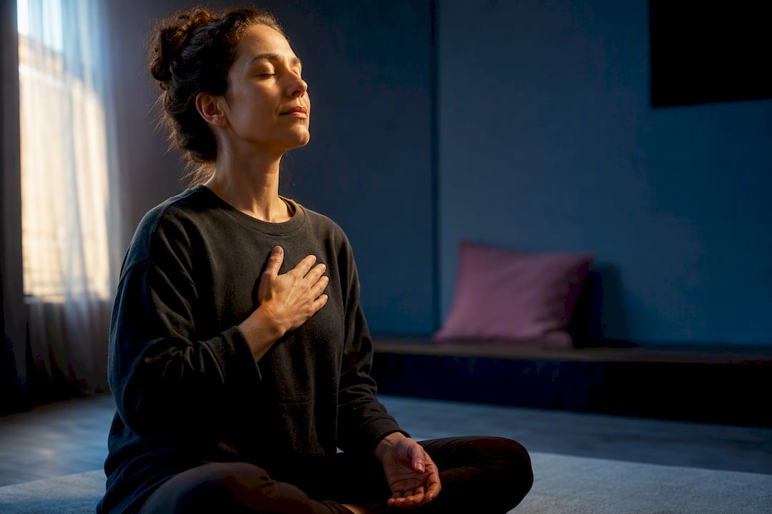 Adult practicing self compassion with hand on heart