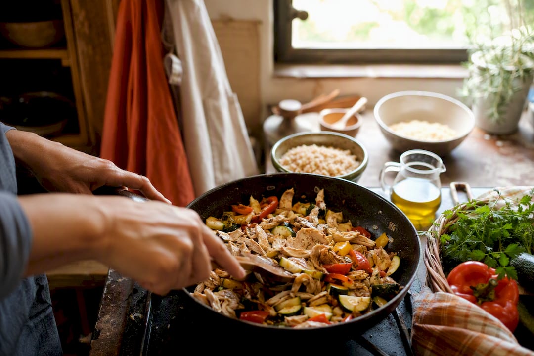 Hands preparing leftover ingredients in kitchen
