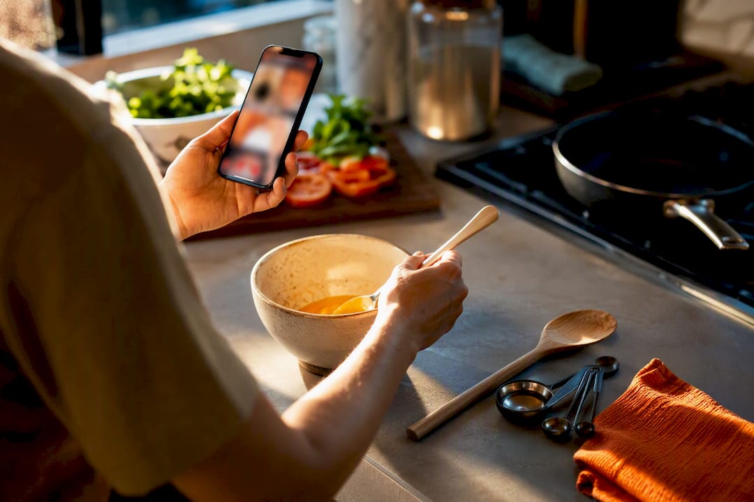 Hands transcribing a cooking video recipe