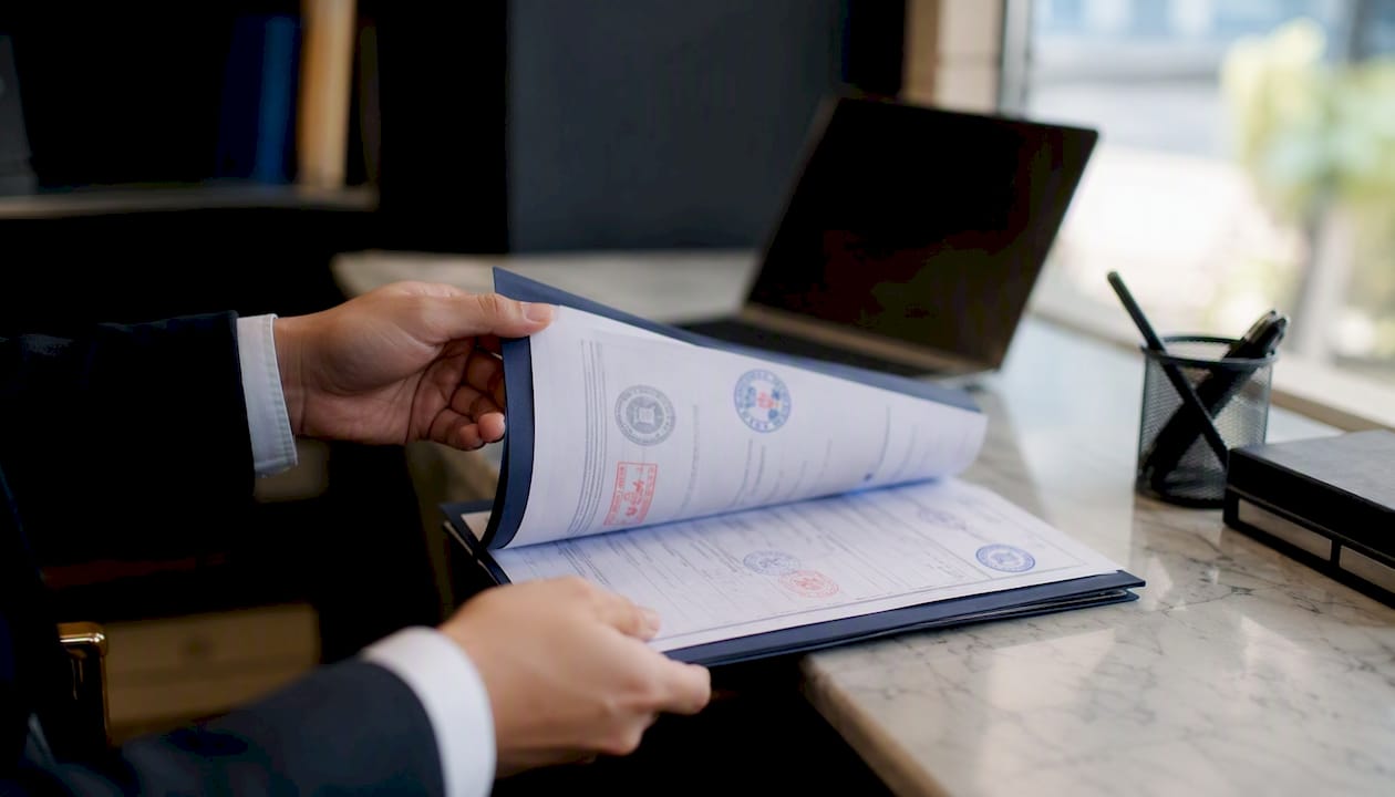 Hands holding translated criminal record and apostille