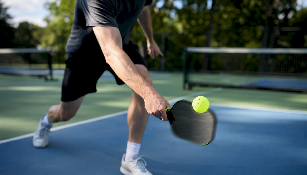 Wrist flicking paddle in pickleball swing