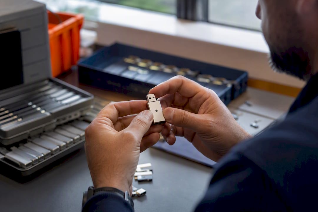 Hands holding USB cryptographic verification token