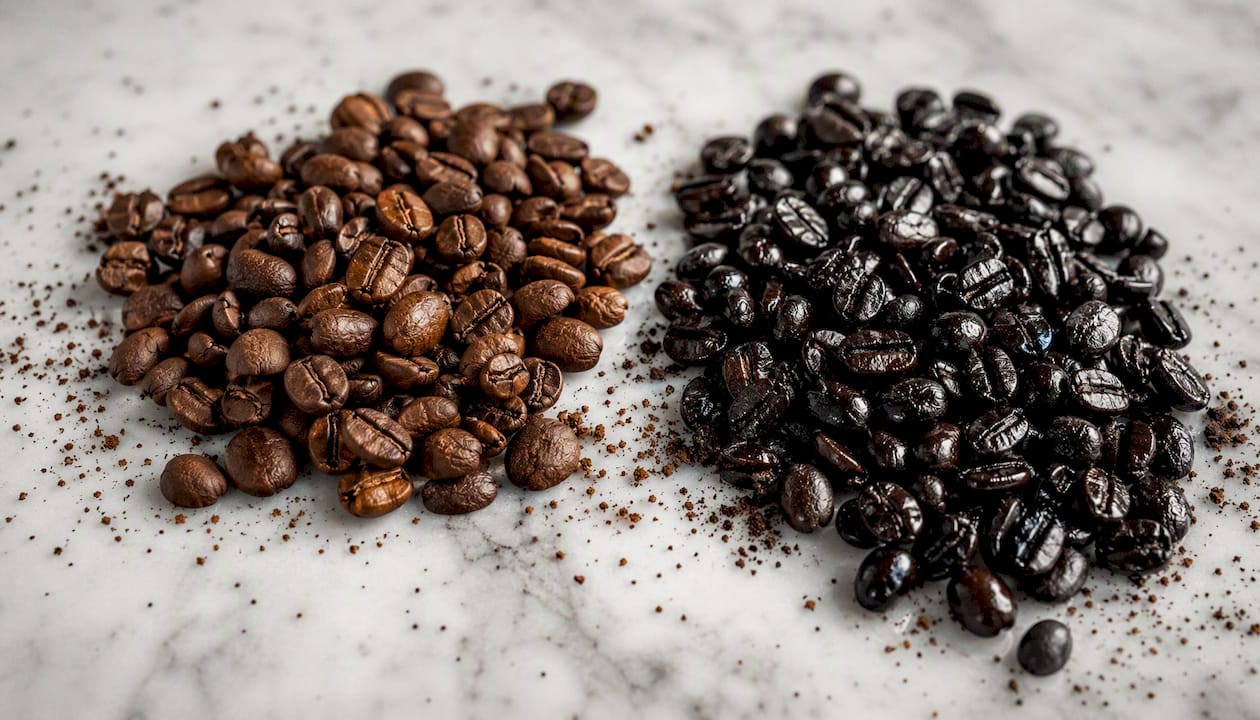 Side-by-side light and dark roasted coffee beans