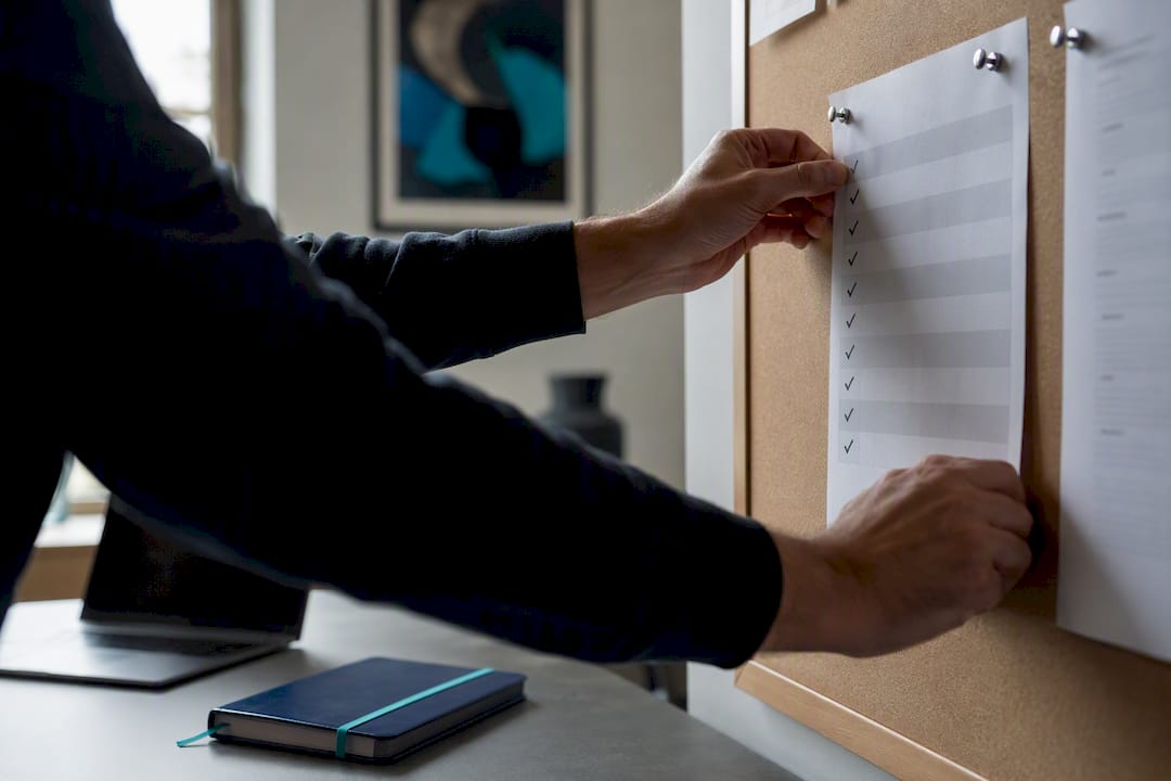 Hands adjusting risk assessment checklist at desk