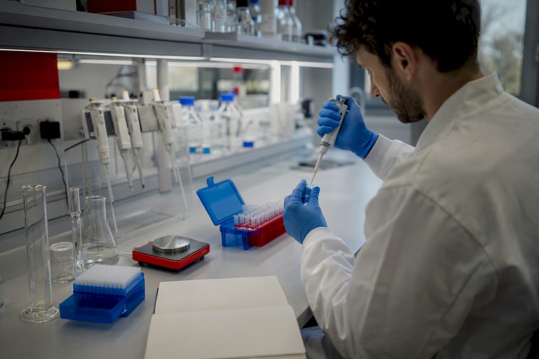 Scientist pipetting validation assay samples
