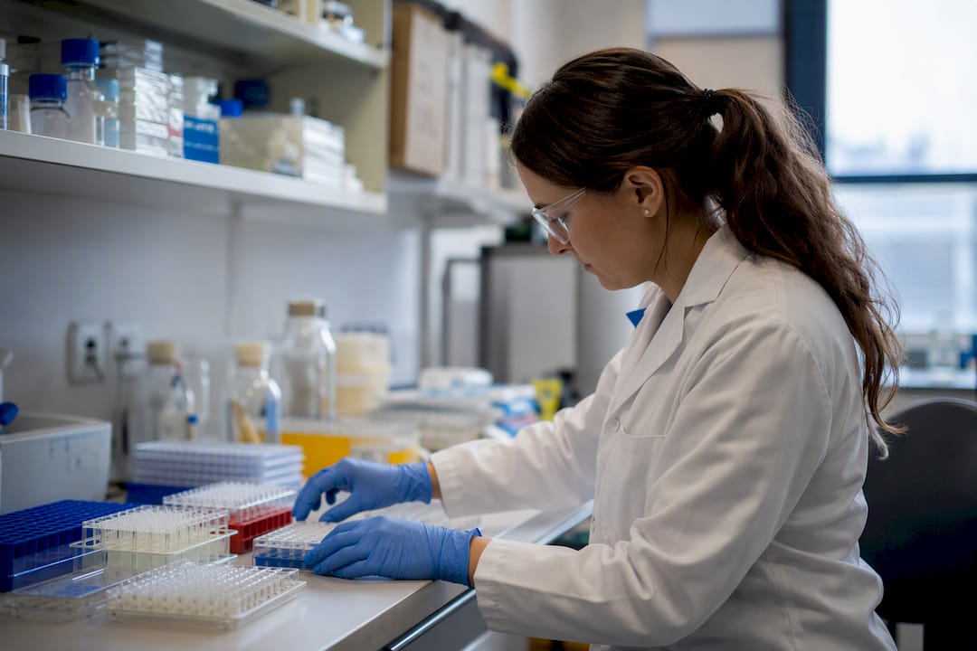 Hands selecting lab consumables in research setting