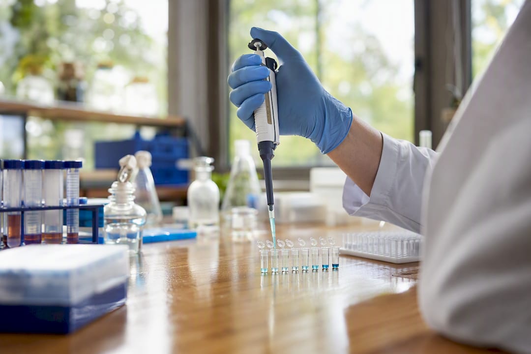 Hand performing dilution series of biological samples