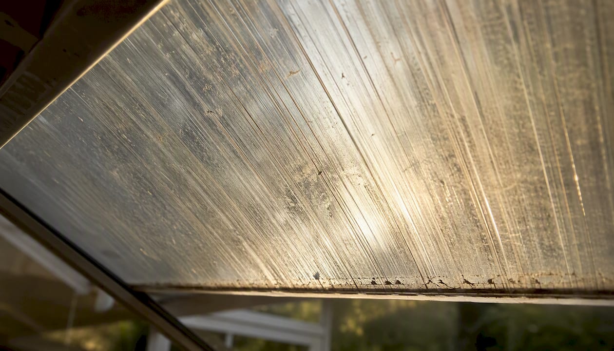 Scratched polycarbonate conservatory roof panel close-up