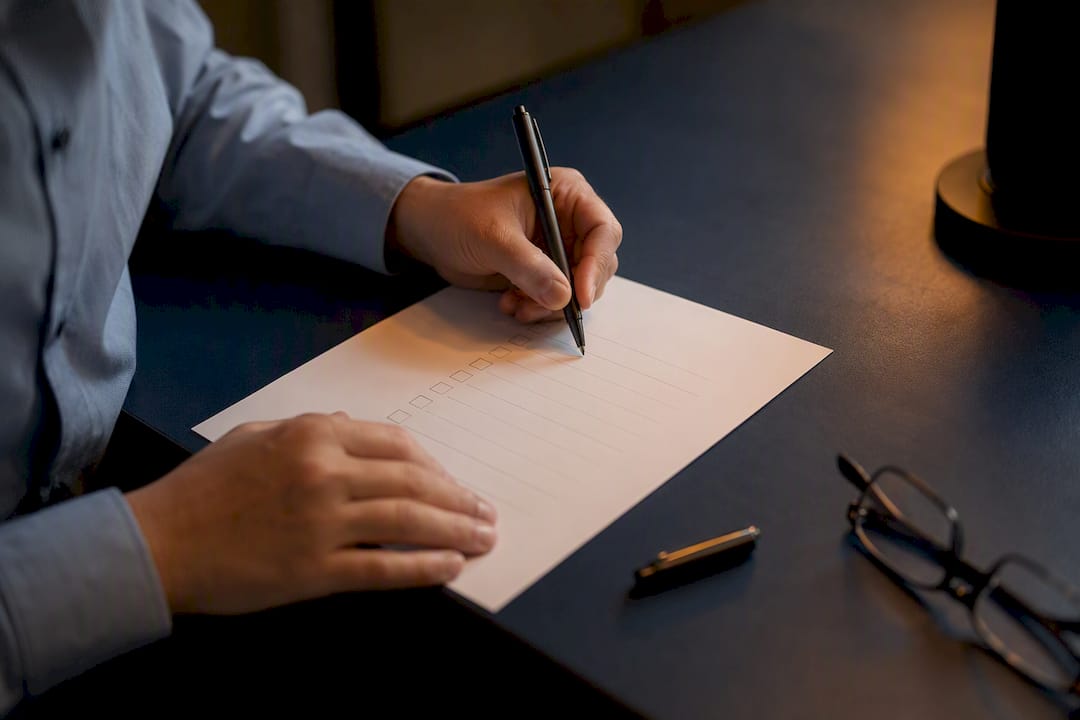 Hands marking verification checklist