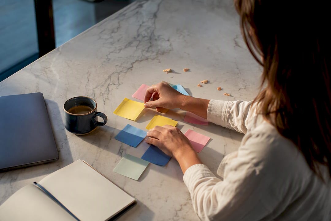 Hands organizing hashtag category notes