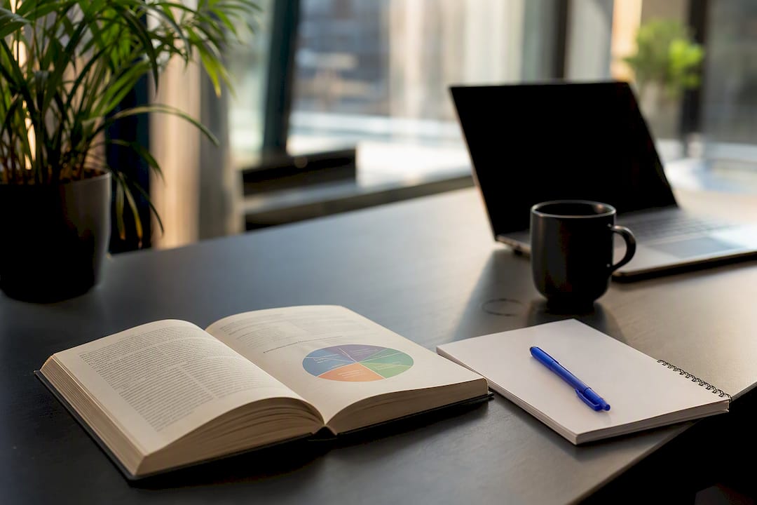 Open psychology books and blank notebook on desk
