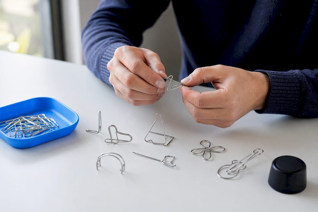 Hands arranging paperclip alternative uses