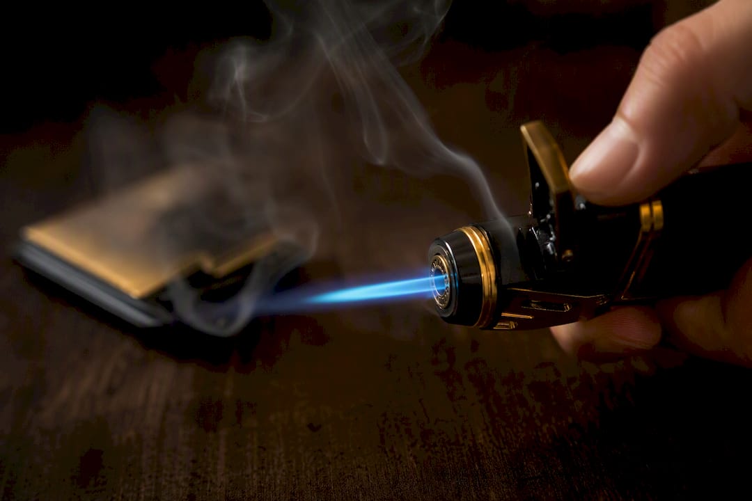 Close-up of blue torch lighter flame being tested