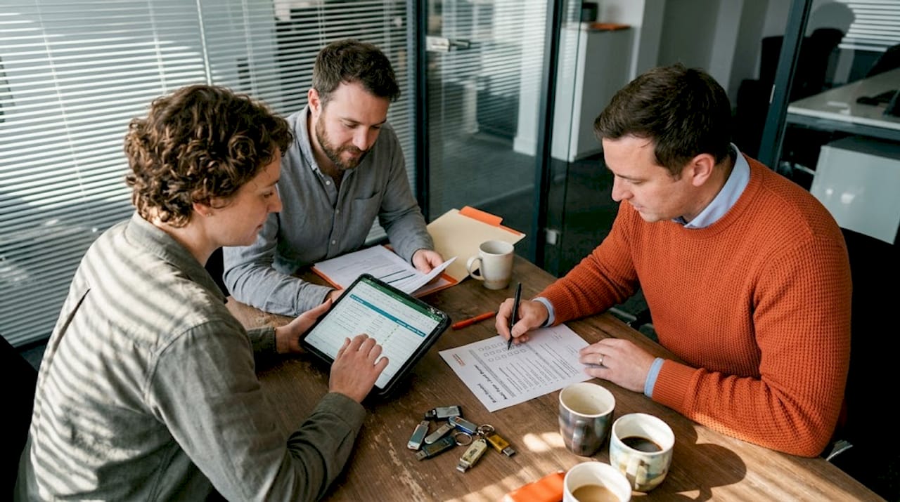 Office team conducting manual audit meeting