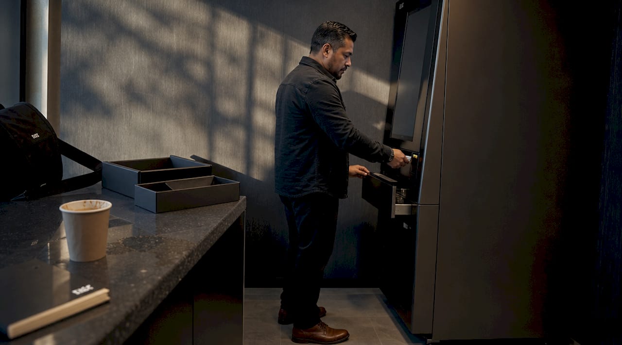 Two staff using automated device vending machines